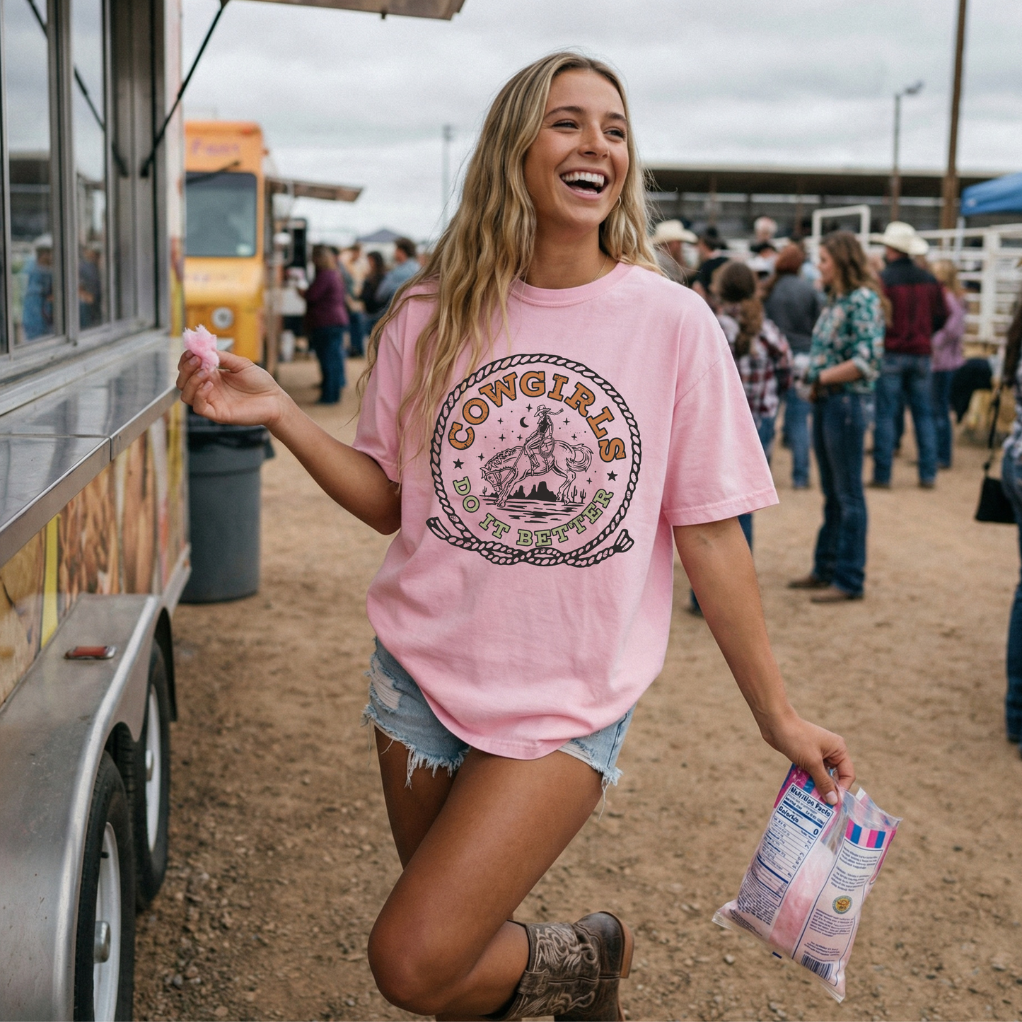 Woman wearing pink Cowgirls Do It Better Comfort Colors western graphic tee at a rodeo