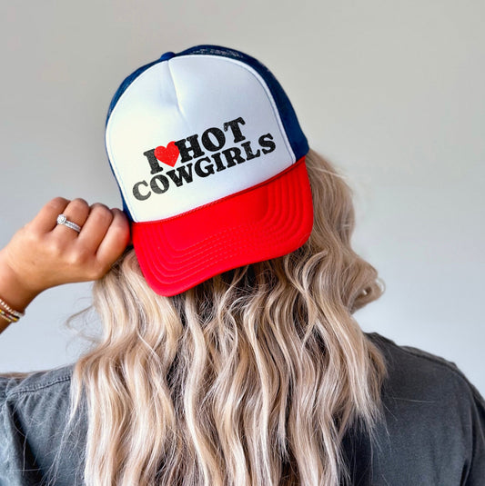 Person wearing a cap with 'I ❤️ HOT COWGIRLS' text on a plain background